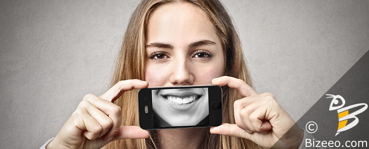 Mobile First Design in Montgomery, AL - smiling woman with smartphone camera