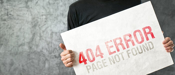 Website Outsourcing in Montgomery, AL - man holding large sign that reads "404 Error"